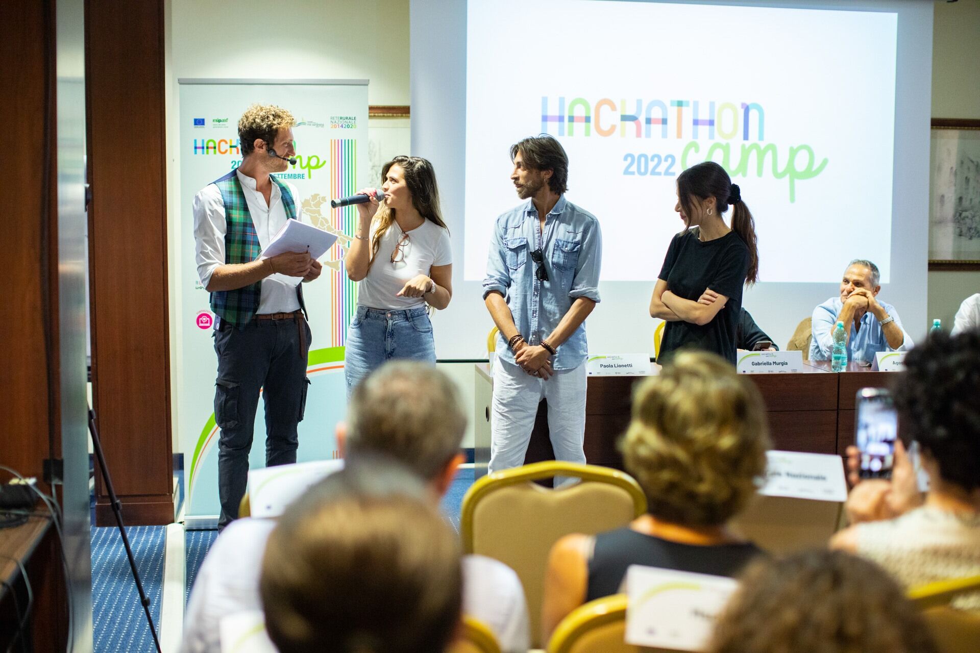 People speaking on a stage