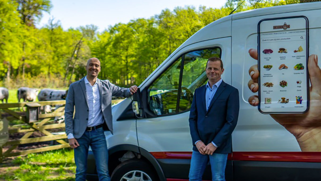 2 men posing in front of a Lokalist van