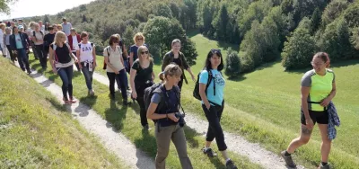 A group of people walking on a path in the mountain
