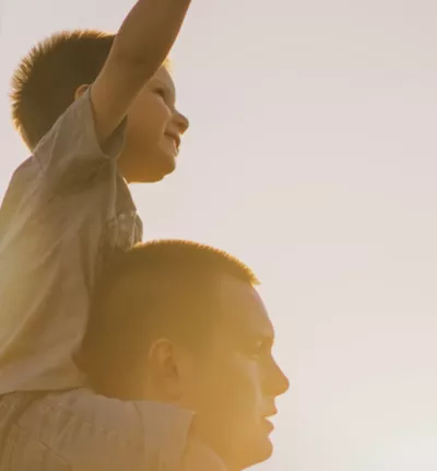 A child on his dad's shoulders