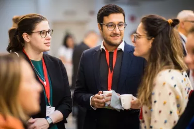 A group of participants network during the coffee break of an event