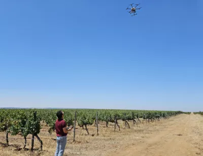 A man flying his drone over his field