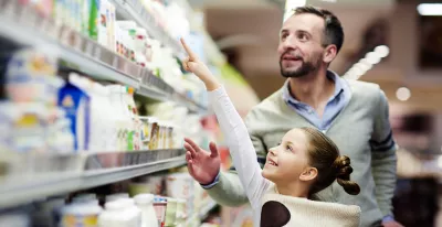 Young girl and her father choosing products in a store