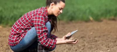 Farmer woman checking soil quality