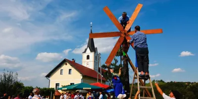 A group of people assembling a windmill in Slovenia.