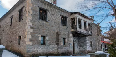 A stone building with snow on the ground