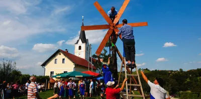 a group of people standing on a ladder on a wooden structure