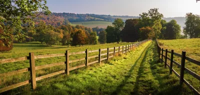Autumn countryside scene with wooden fence and trees, showcasing the beauty of the season.
