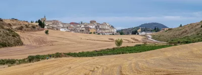 Agricultural fields of cereal, vineyards and town of Cirauqui