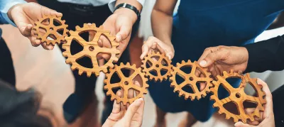 hands holding cog wheels