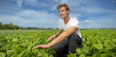 Young farmer in field of crops