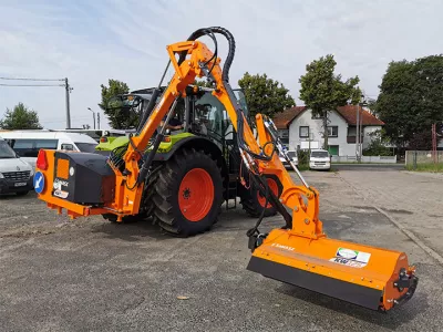 Orange tractor equipped to clear the vegetation from ditches. (Logo)