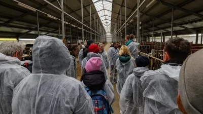 A group of people in white raincoats