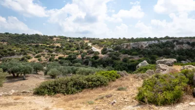 A view of a rocky hillside with trees and bushes