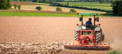 A person driving a tractor in a field