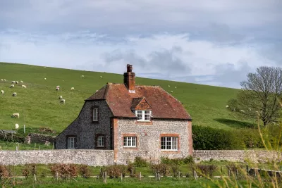 Rural English house and grazing sheep