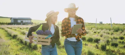 Mother and daughter farmer work together in wheat field