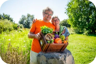 farmers carrying box of vegetables