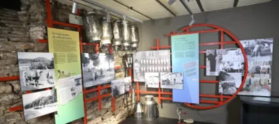 A museum room with a wall with signs and pictures