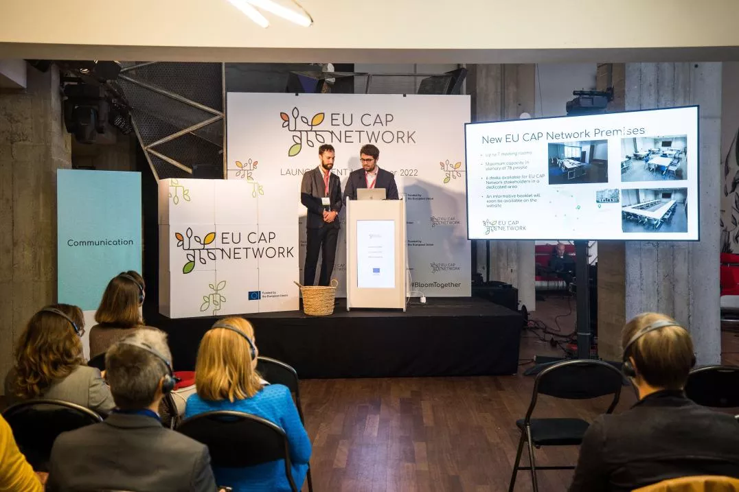 Two men standing on a stage at the launch of EUCAP NETWORK