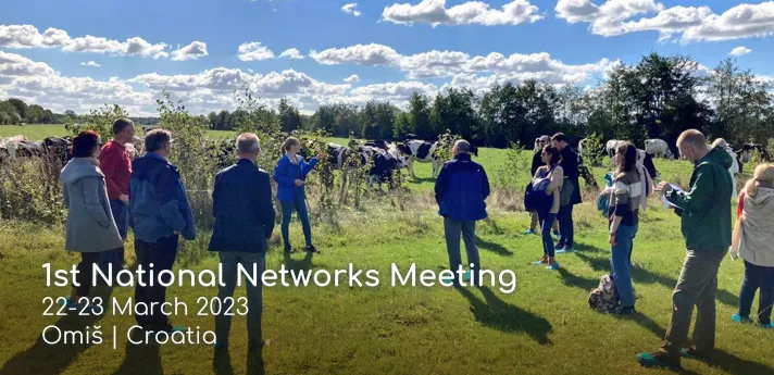 A group of people standing in a field for the "1st National Networks Meeting"