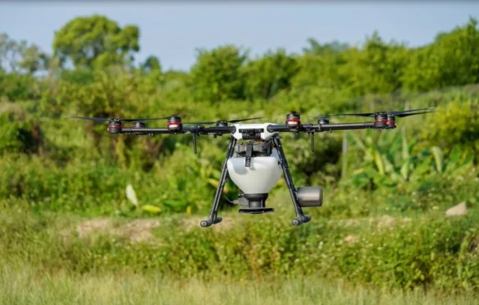 Drone flying over a field close to the ground.