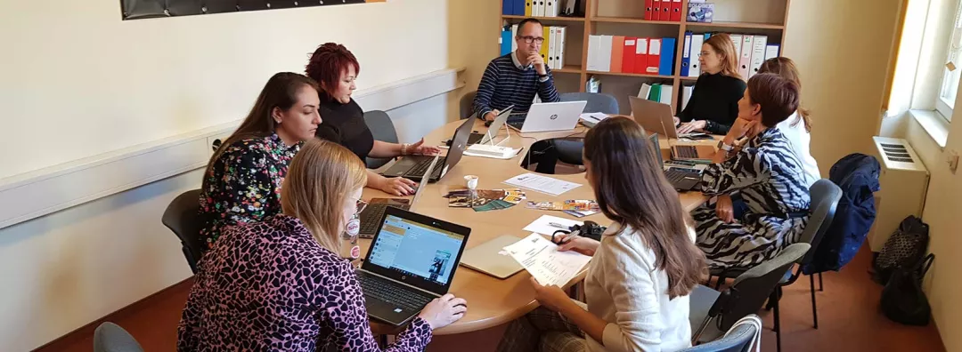 People working in a group around a table