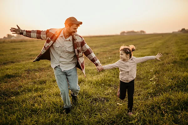 Father and daughter walking outdoors