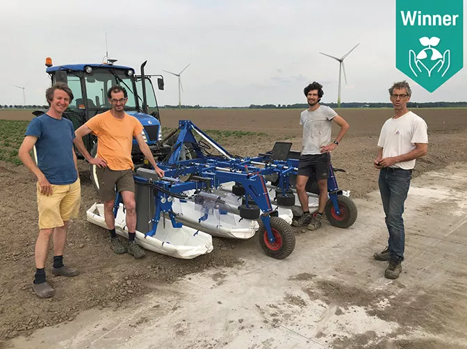 a group of men standing next to a blue and white tractor