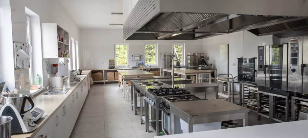 A modern kitchen with stainless steel appliances, including a large oven and a spacious countertop