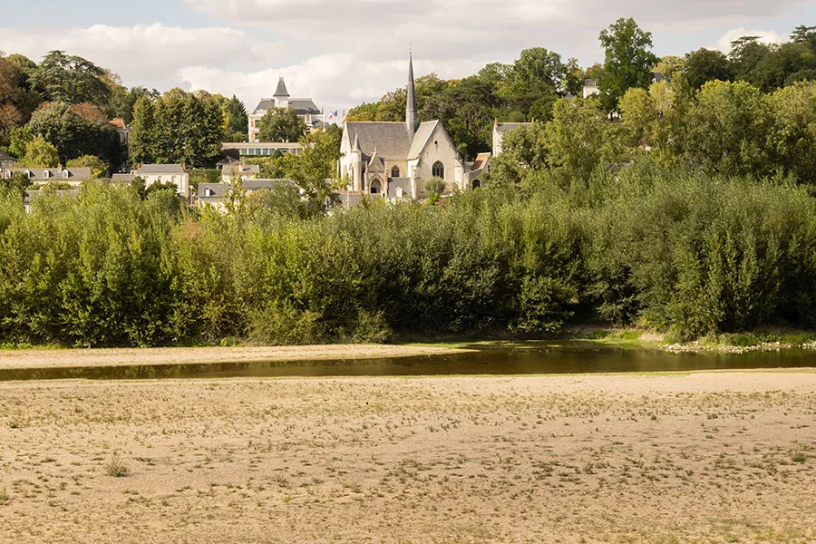 Chapel Église Saint-Cyr et Sainte-Julitte and diminished river Loire in rural France