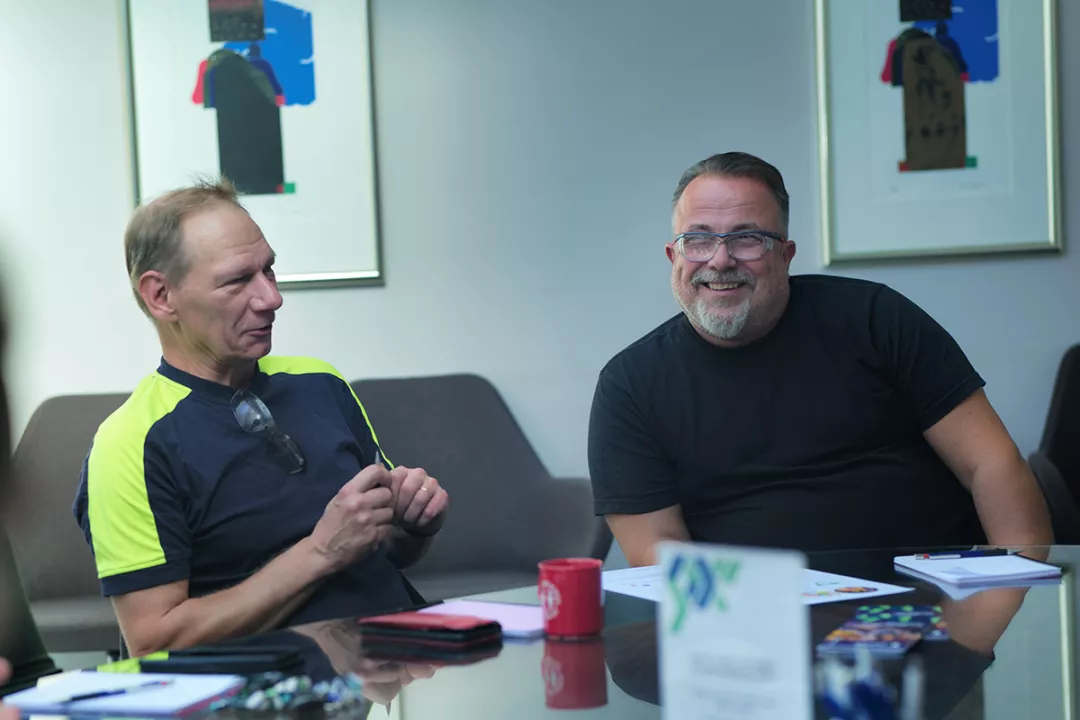 two project participants chatting