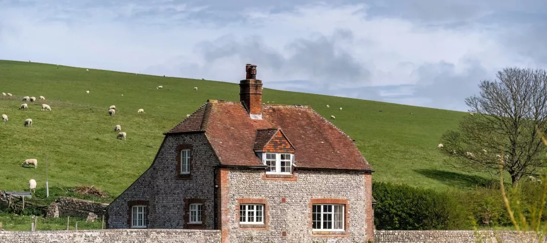 Rural English house and grazing sheep