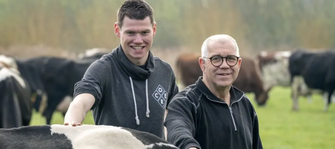 Bart Combee with his dairy cows and an older male farmer