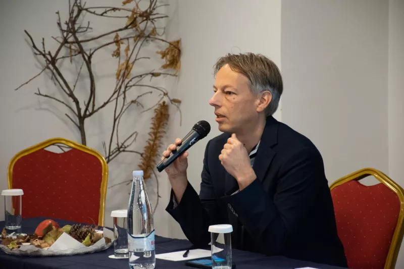 a man sitting at a table with a microphone at the workshop "How to assess direct payment interventions in the new CAP"