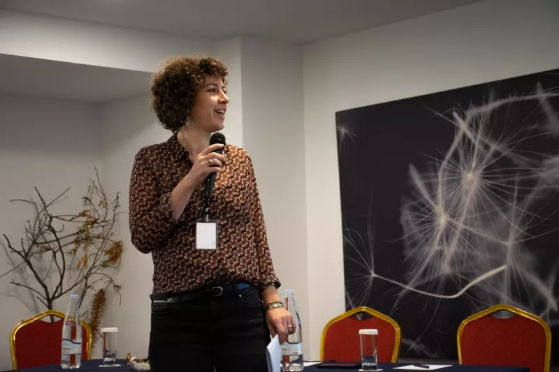 a woman standing, holding a microphone at the workshop "How to assess direct payment interventions in the new CAP"