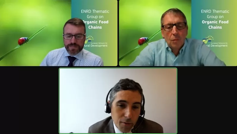 Three men wearing a headset during a meeting at the "Thematic Group on Strengthening the position of farmers in the organic food supply chain"