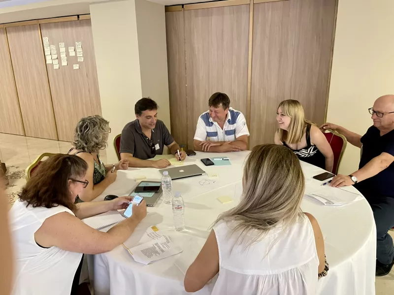 participants sitting on a table discussing