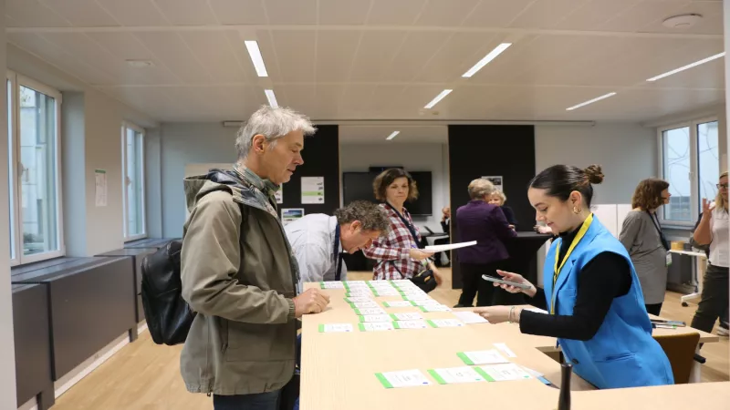 Attendees registering and collecting materials at the event