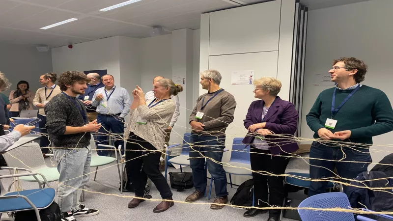 Participants holding interconnected strings in a network exercise