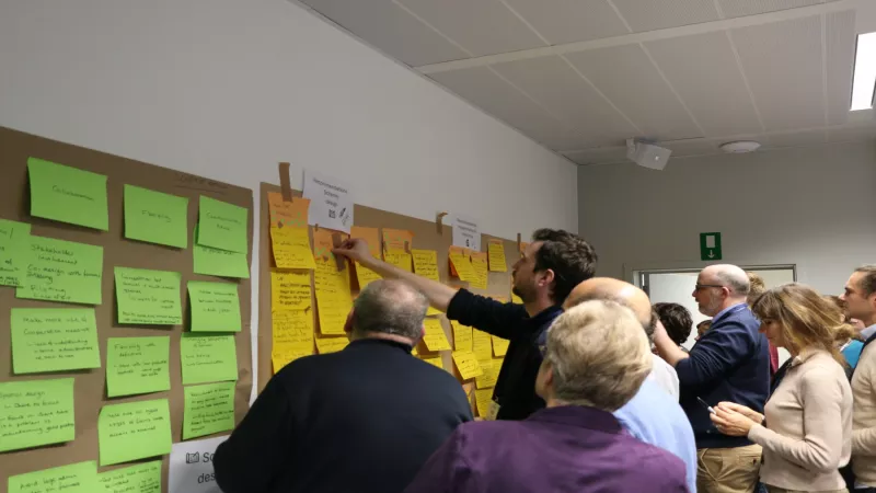 Participants adding sticky notes during workshop