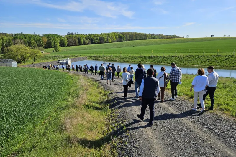 Big group of people walking by the river during event