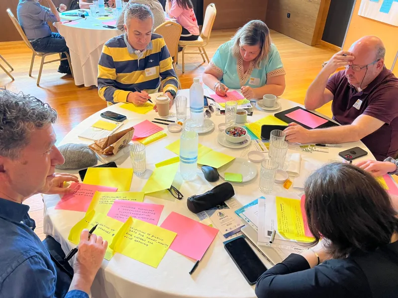Group working on their ideas to wall of collaboration