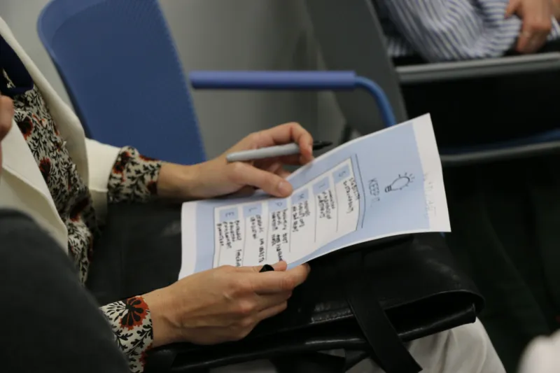 TG member holding a piece of paper