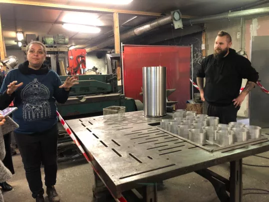 a group of people standing next to a table