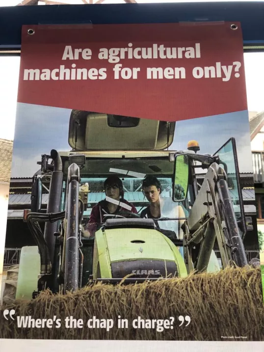 A poster with two people in a tractor