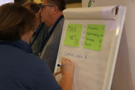 Participant writing on a board