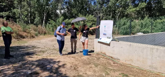 Two people presenting outside