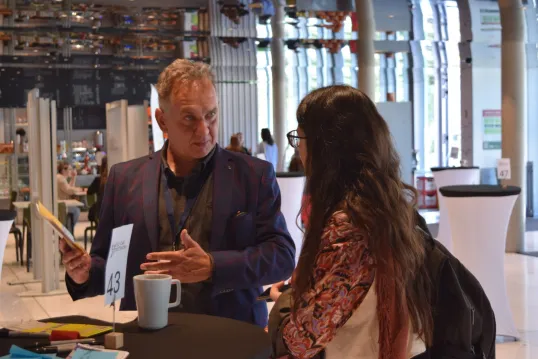 Man and woman discussing during event