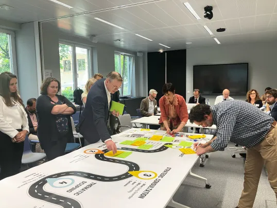 Steering Group members putting post-its on the AWP roadmap